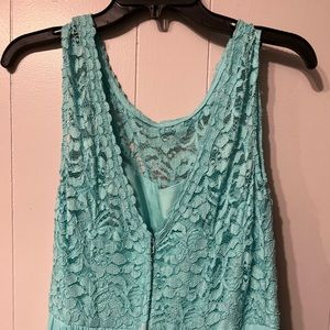 A “Spa” color sleeveless bridesmaid dress from David’s Bridal.